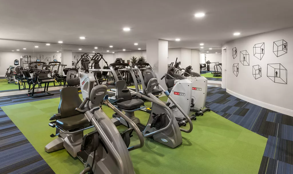 A modern gym with various fitness equipment and exercise machines.