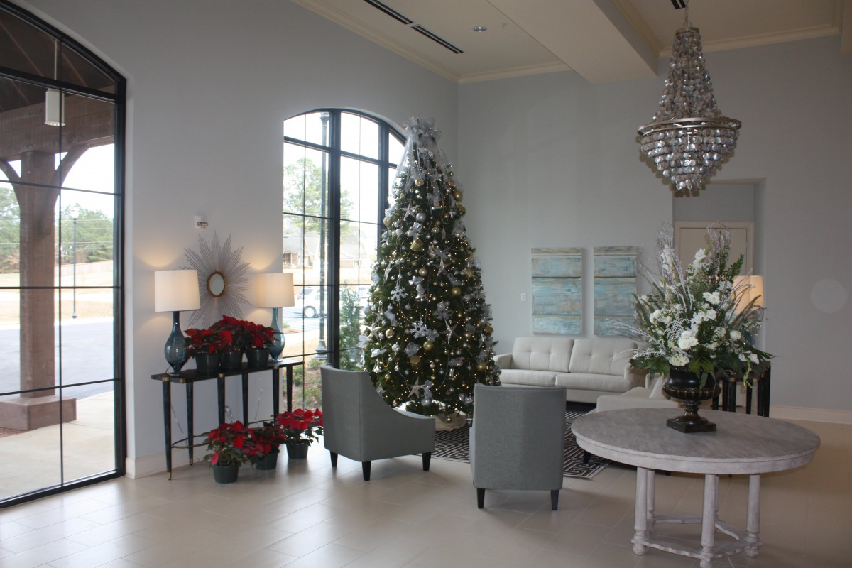 A beautifully decorated living room with a Christmas tree and festive holiday decorations.