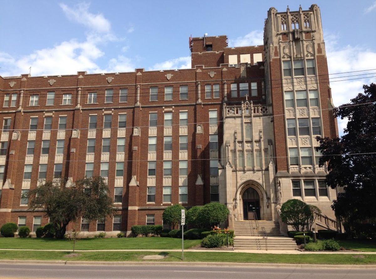 A historic brick school building with a prominent entrance.