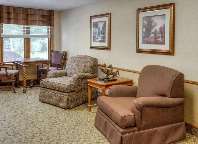 A cozy living room with comfortable chairs and decorative artwork.