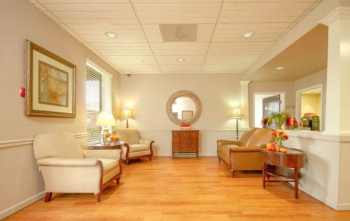 A cozy waiting room with comfortable seating and warm lighting.