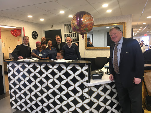 Staff members gather at the reception area to celebrate a special occasion.