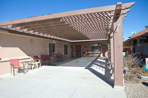 A sunny outdoor patio with a pergola, perfect for relaxation.