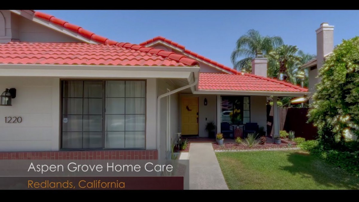 A cozy suburban house with a red-tiled roof and well-maintained front yard in California.
