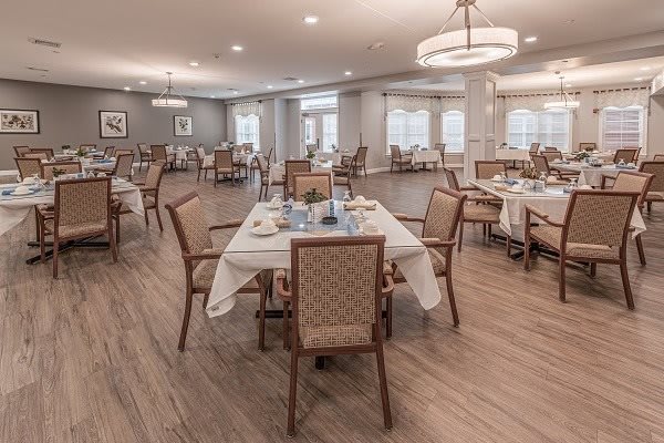 An elegant dining room with neatly arranged tables and chairs, featuring a spacious and well-lit interior.