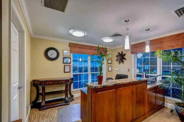 A welcoming reception area with a wooden desk and decorative elements.