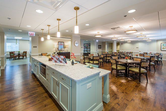 A well-lit dining area with neatly arranged tables and chairs, featuring stylish interior decor.