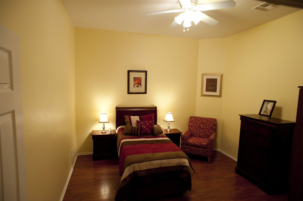 Cozy bedroom with a single bed and warm lighting.