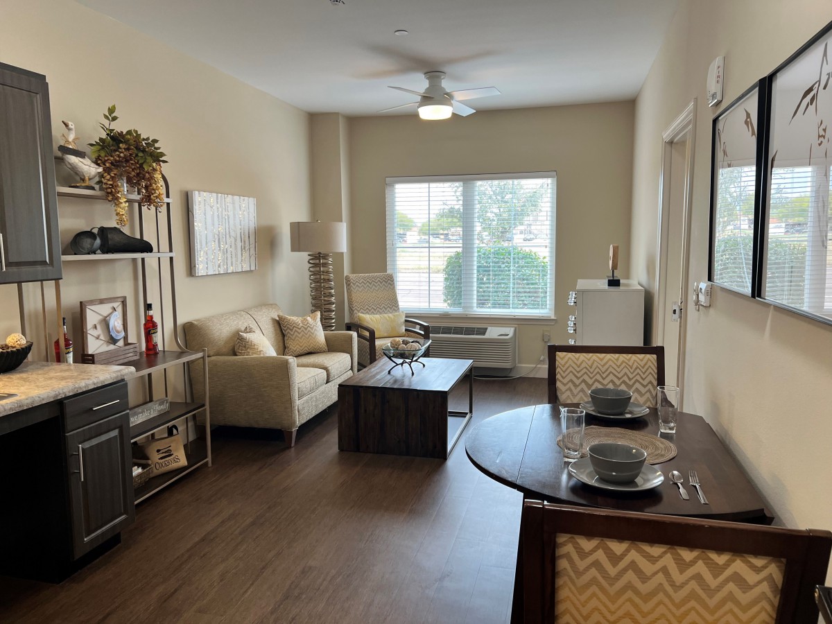 A cozy living room with a dining area featuring modern furniture and decor.