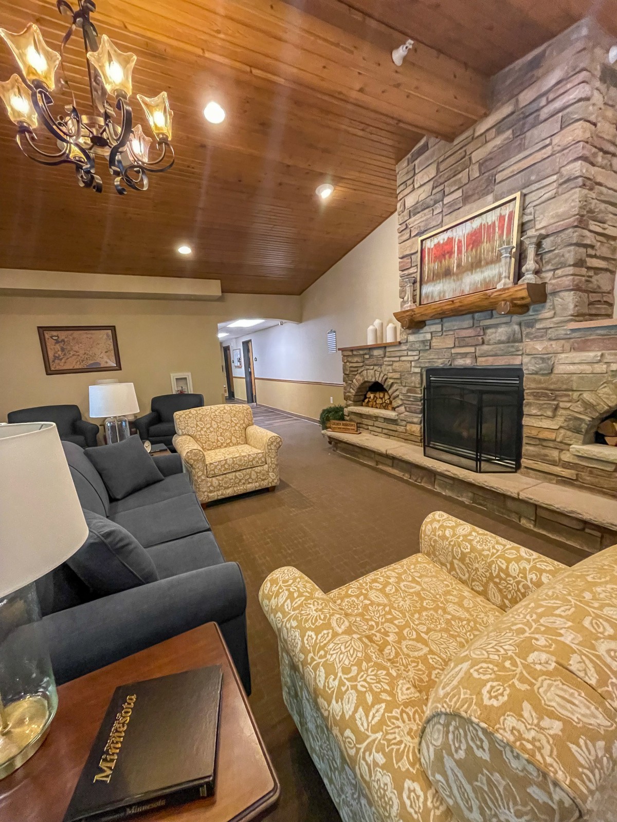 Cozy living room featuring a stone fireplace and comfortable seating.