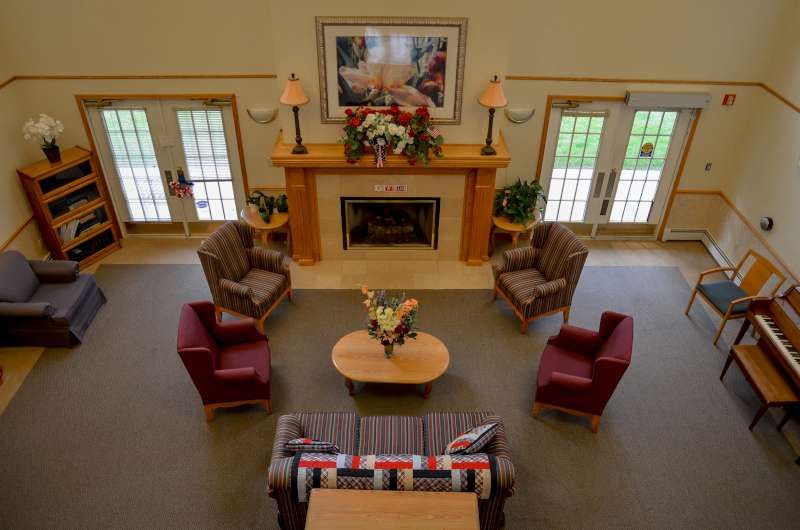 A cozy living room with a fireplace and comfortable seating arrangement.