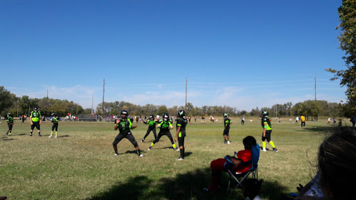 A football team practicing on a sunny day, showcasing teamwork and athleticism.