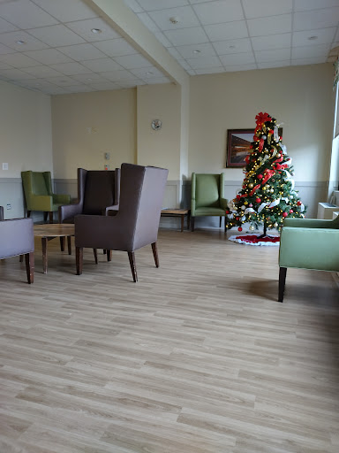 A cozy waiting area with comfortable seating and a decorated Christmas tree.