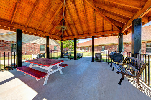 A spacious outdoor pavilion featuring a picnic table, perfect for gatherings and relaxation.