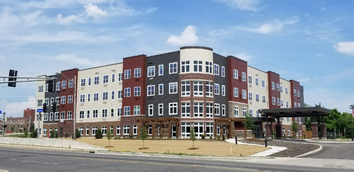 A modern apartment building with a unique design and multiple floors.