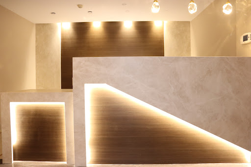 A sleek and modern reception area featuring minimalist design elements and ambient lighting.
