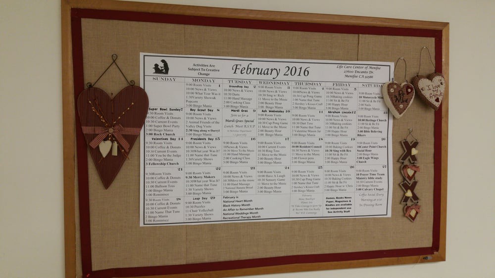 A bulletin board features a February 2016 calendar decorated with heart-shaped ornaments.