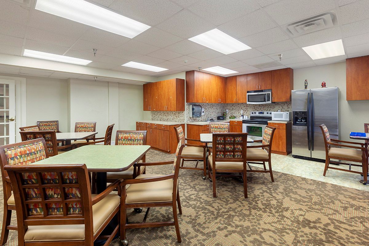 A modern kitchen and dining area with tables and chairs.