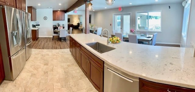 Modern kitchen with an open concept design and a central island sink.