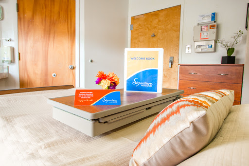 A cozy room setup featuring colorful informational materials on a table with a decorative floral arrangement.