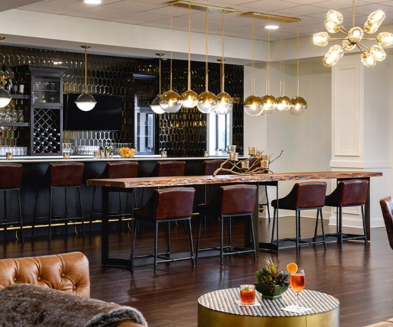 A stylish modern bar area with contemporary pendant lighting and chic seating arrangements.