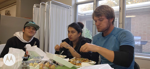 Two individuals enjoying a meal together in a casual setting.