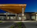 A modern building entrance lit up at night.