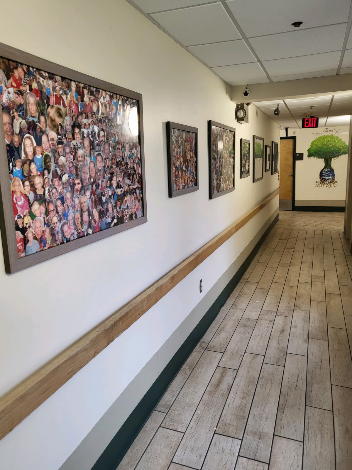 A hallway with framed photographs and artwork displayed on the walls.