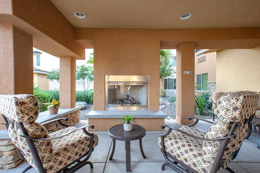 A cozy outdoor seating area featuring a modern fireplace, perfect for relaxing and enjoying the surroundings.