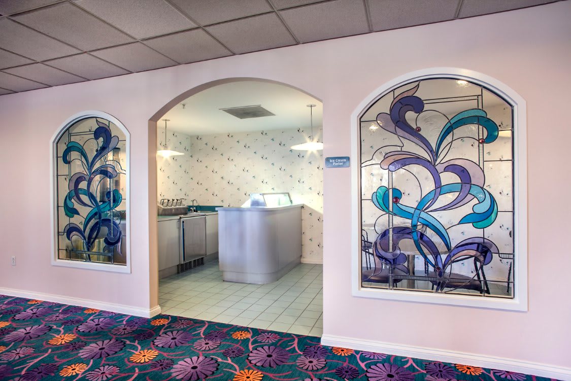 A hotel laundry room with washing machines and vibrant decor.
