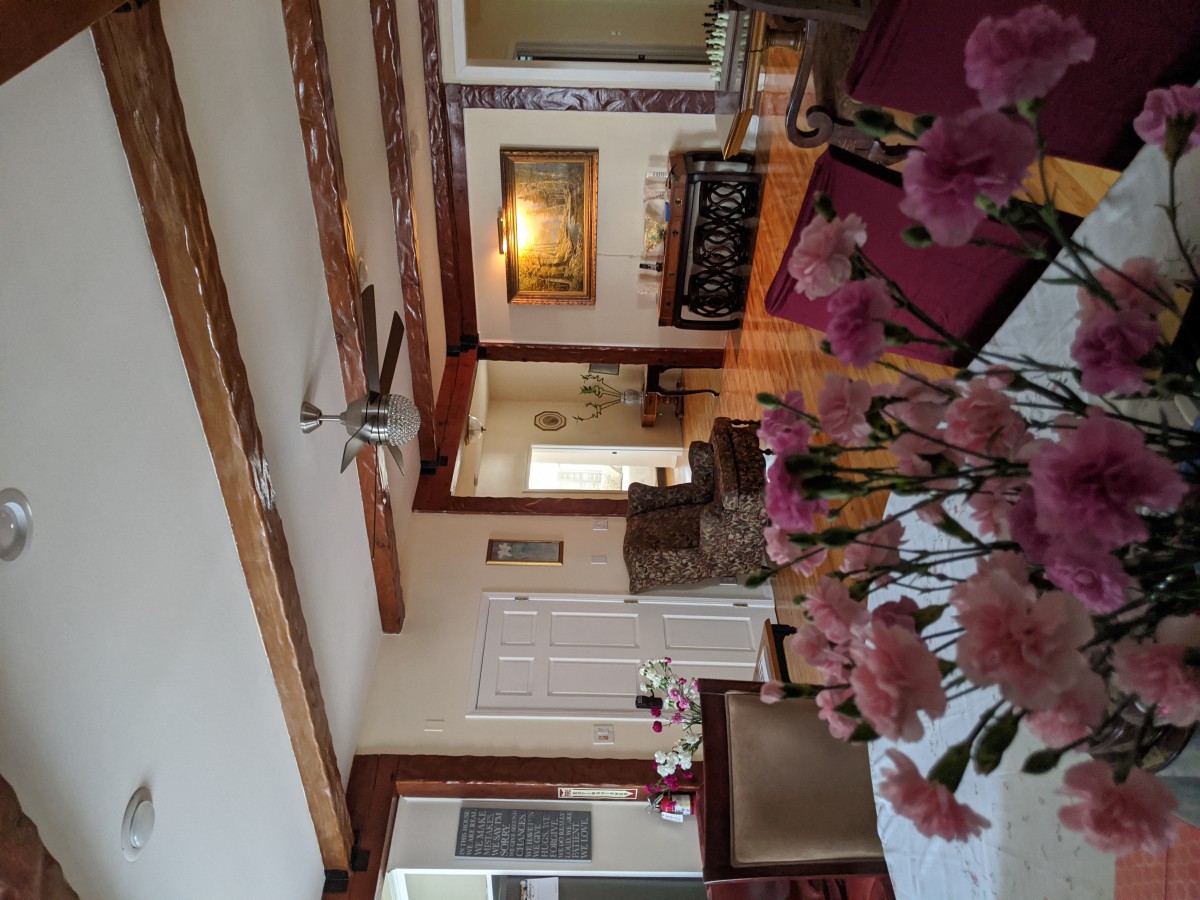 A cozy living room with flowers and elegant furnishings.