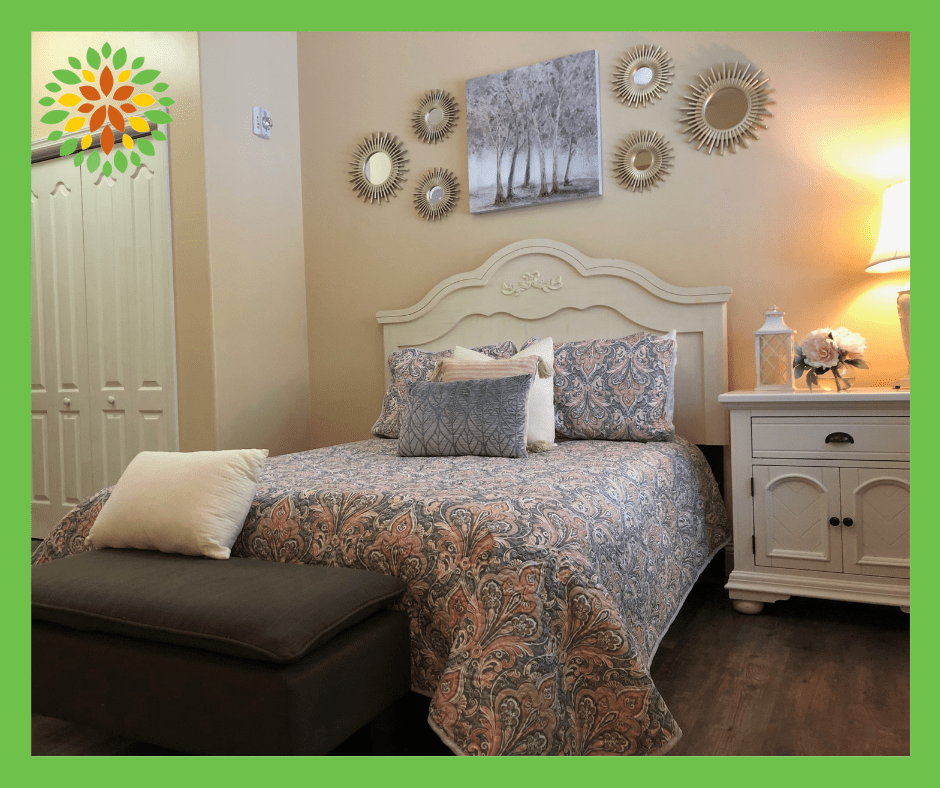 A cozy bedroom with a neatly made bed, decorative pillows, and wall art that creates a serene ambiance.