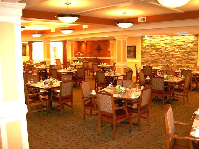 An interior view of an empty restaurant dining area with neatly arranged tables and chairs.