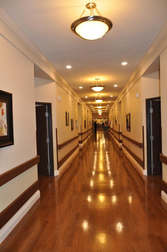 A well-lit corridor showcasing elegant designs and art on the walls.