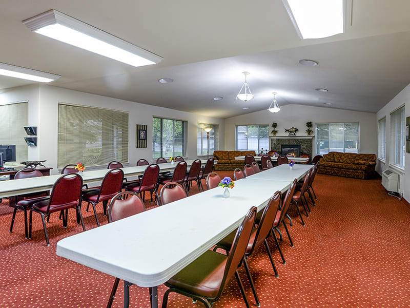 A spacious conference room with a long table and chairs arranged for a meeting.