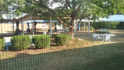 A serene playground setting surrounded by greenery.