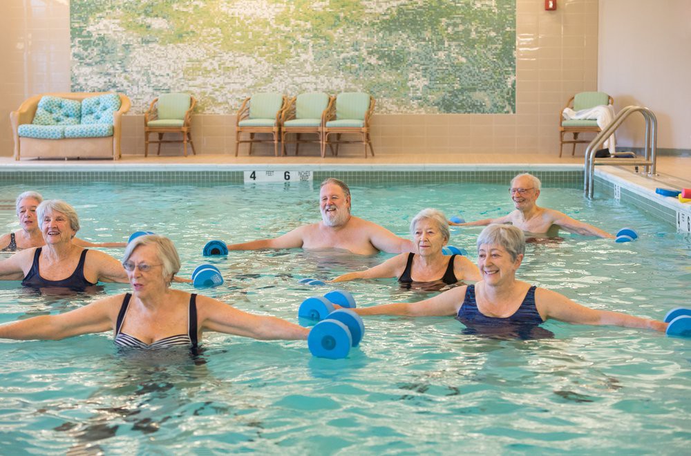 A group of seniors participating in a water aerobics class.