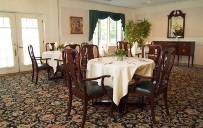 A cozy dining room with elegantly set tables and classic decor.