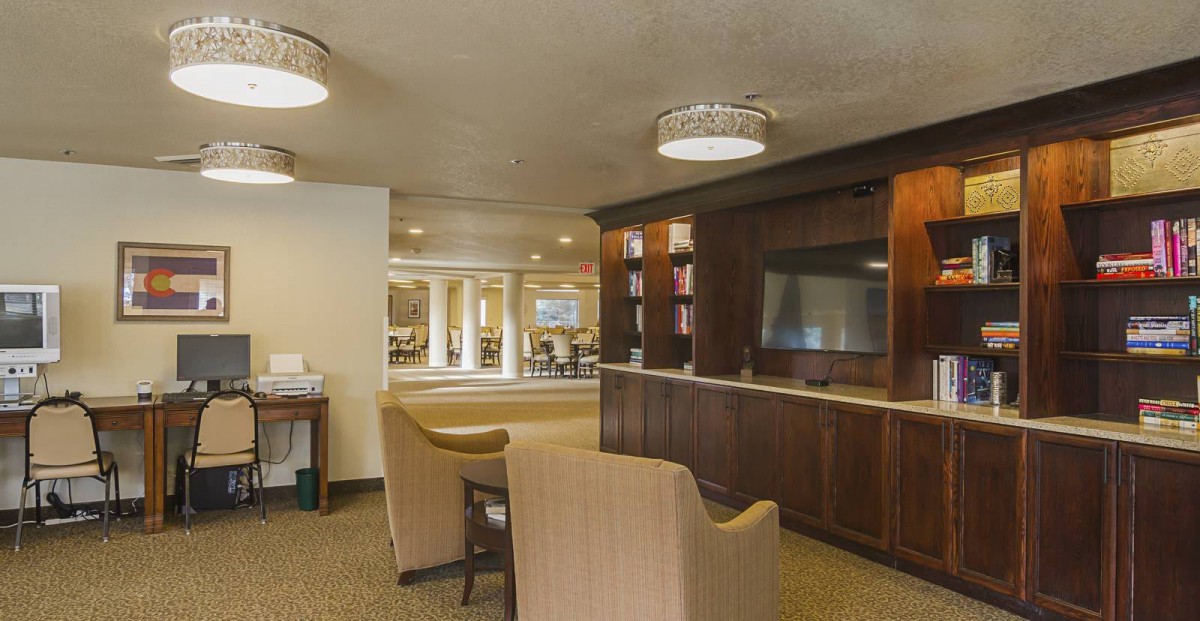 A modern lobby area with comfortable seating and a large television.