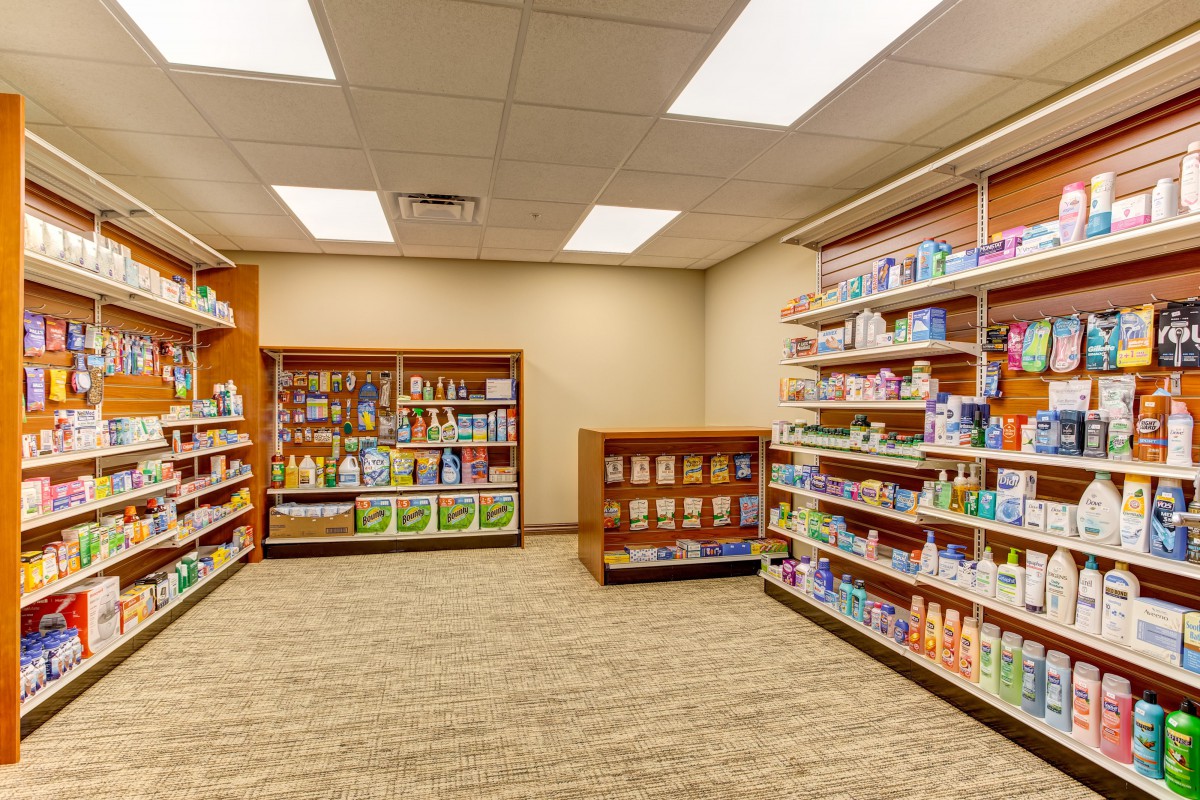 An interior view of a pharmacy with well-organized shelves displaying various products.