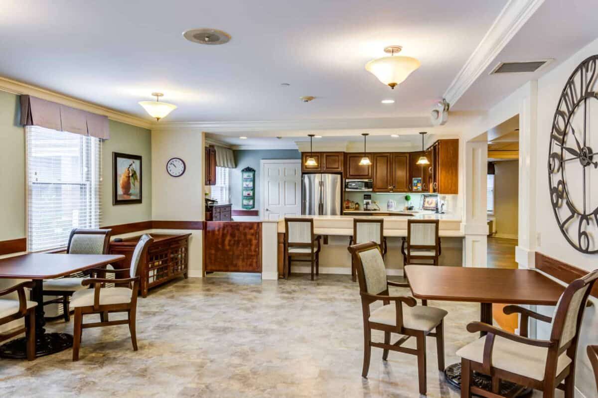 A modern kitchen and dining area with ample lighting and stylish furniture.
