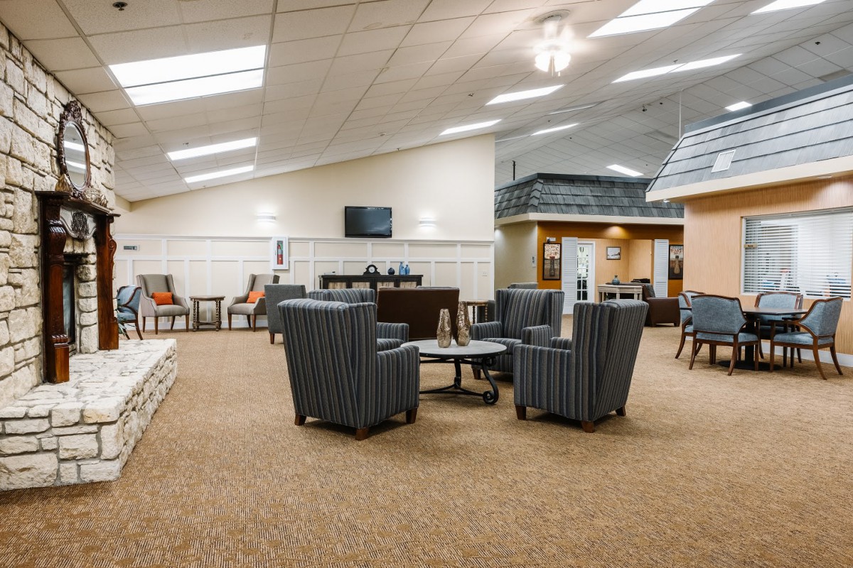 A spacious lobby area with comfortable seating and a television.