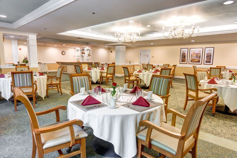A beautifully set dining room with elegant furniture and place settings.