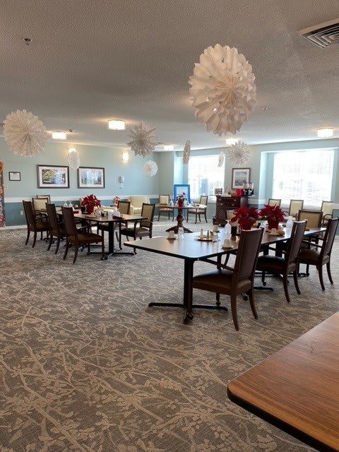 A well-decorated dining area with neatly arranged tables and chairs.