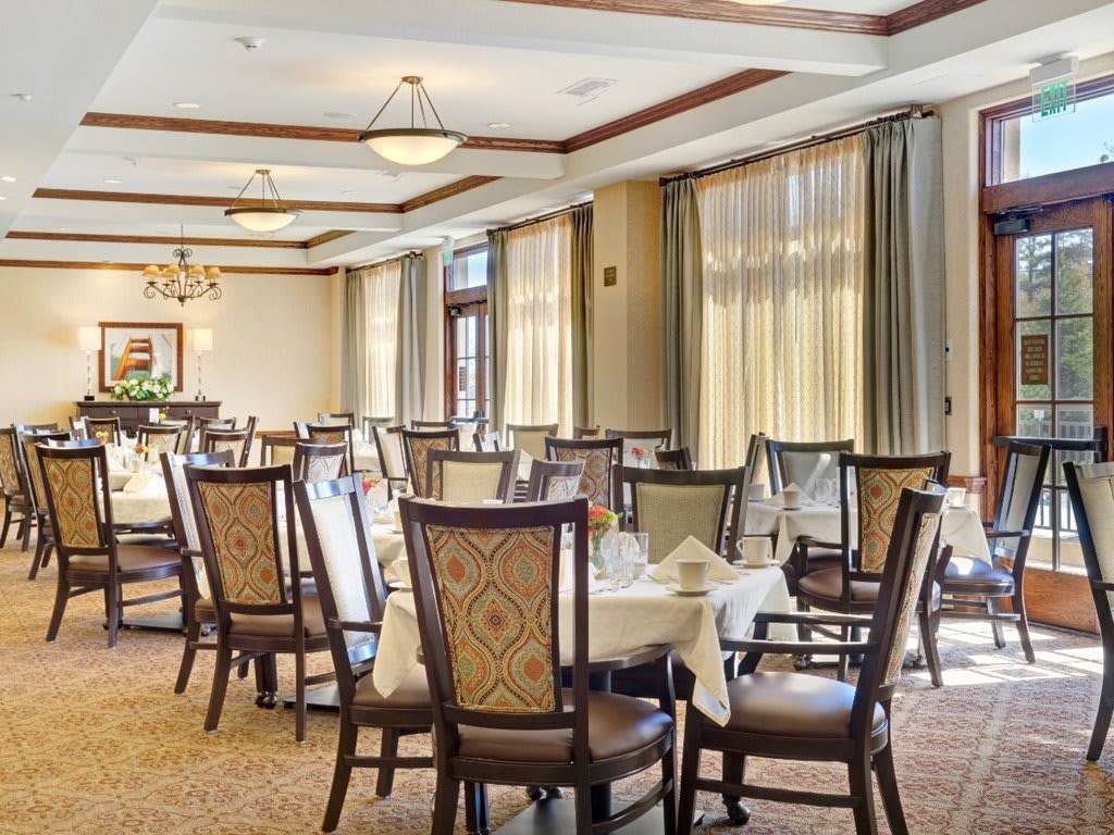 An elegant dining room with neatly arranged tables and chairs, ready for guests.