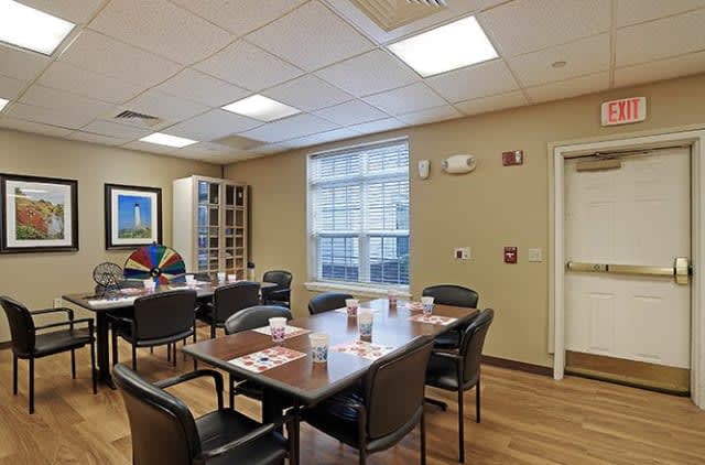 A well-lit conference room with a large table and chairs, set up for a meeting.