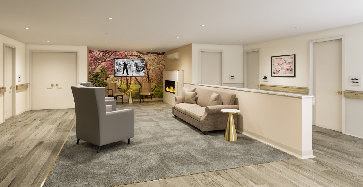 A cozy living room with modern furnishings, featuring a sofa, armchair, fireplace, and television.
