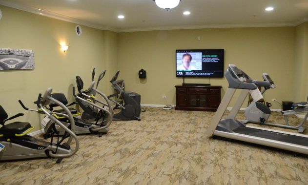 A cozy gym with exercise equipment and a television.