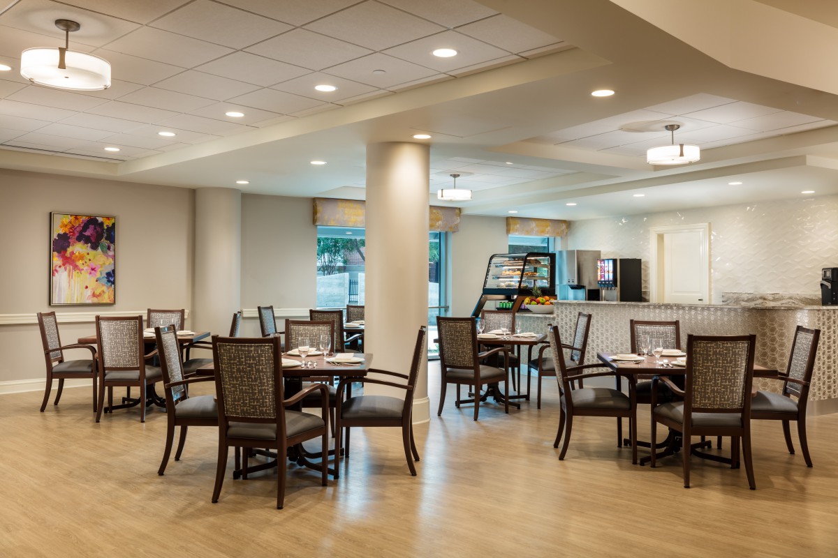 A modern and spacious dining area with neatly arranged tables and chairs.