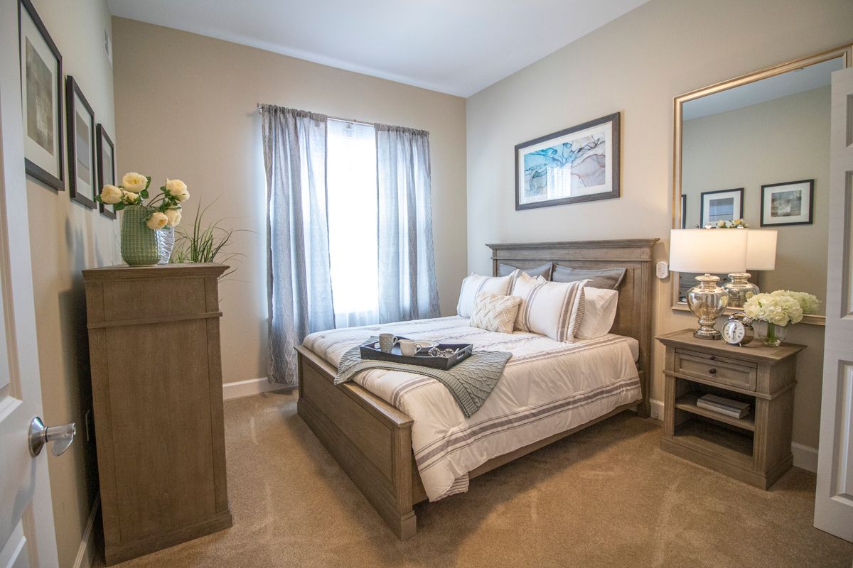 A cozy and well-decorated bedroom with a comfortable bed, soft lighting, and tasteful furnishings.